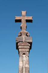 Medieval column with cross on sunny summer day. Hovhannavank monastery, Aragatsotn Province, Armenia.