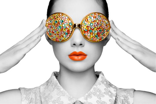 Portrait of beautiful young woman with colored glasses. Beauty fashion. Perfect make-up. Colorful decoration. Jewelry