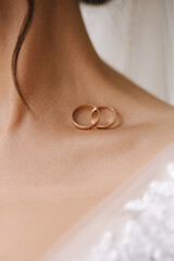 Classic wedding rings on bride's collarbones. Close-up