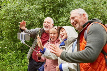 Fototapeta Elderly couples waving on video call through smartphone obraz