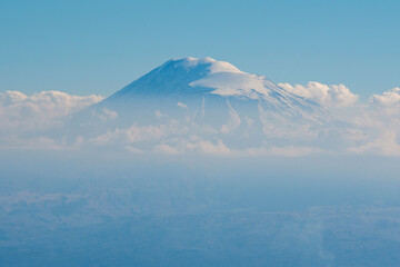 Mount Ararat in the clouds on sunny autumn day. View from Mount Aragats slope, Armenia.