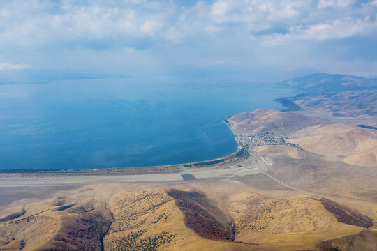 Aerial view of Sevan lake and Shorzha village from above Mount Artanish on sunny autumn day. Gegharkunik Province, Armenia.
