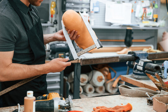 Measures the diameter of the prosthesis. Technician working in modern laboratory