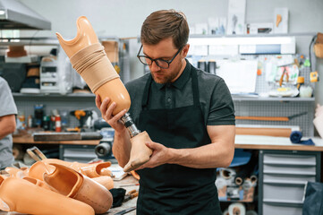 Technician working with prosthesis in modern laboratory