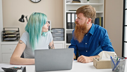 Obraz premium Man and woman business workers using laptop working at office
