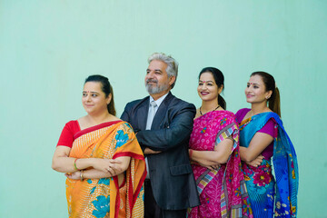 Fototapeta na wymiar Senior businessman standing with women group.
