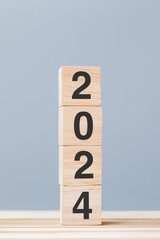 wooden cube block with 2024 text on table background. Resolution, plan, review, goal, start and New...