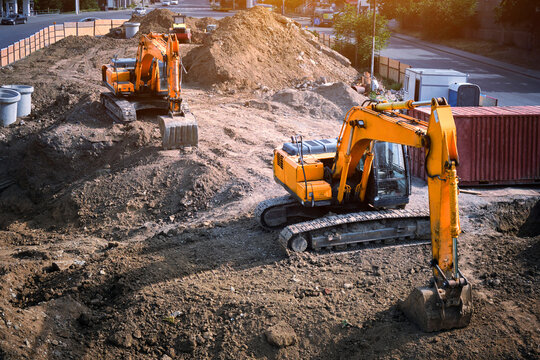 Two excavators are digging the ground for a foundation.