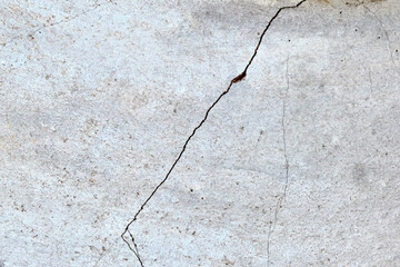 Close-up of a large crack in the wall of a building.