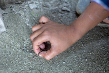 A boy marks the ground with his hands