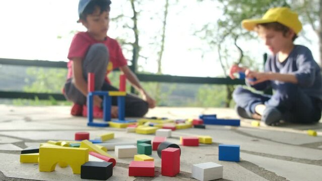 Discover the magic of imaginative play with this captivating stock video available on Adobe Stock. Follow the adventures of two children as they construct colorful wooden towers with construction 
