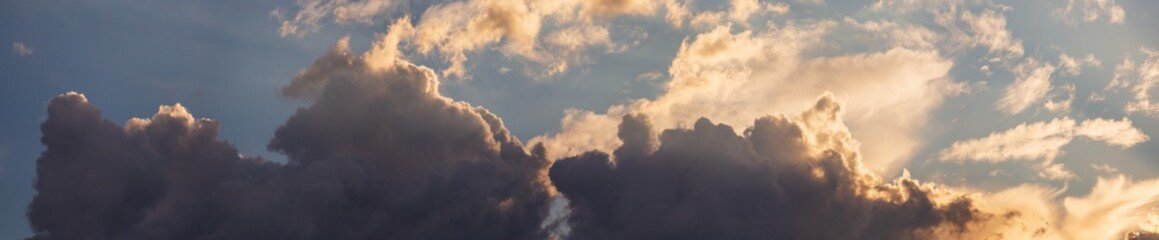 Fototapeta premium Sky panorama. Beautiful dramatic big clouds in the sky. Landscape of the power of heaven and nature. Copy space
