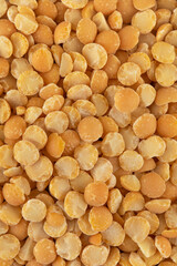 Yellow split dry peas close-up. Vegetable protein. Vertical photo.