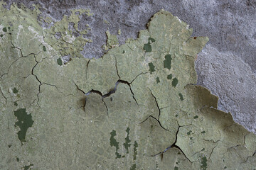 Peeling paint on the wall. Old concrete wall with cracked flaking paint. Weathered rough painted...