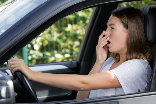 tired beautiful woman driver has sleepy expression