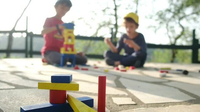 Delve into the world of hands-on learning with this captivating stock video on Adobe Stock. Join two children in their playful exploration as they construct vibrant wooden towers using construction fi