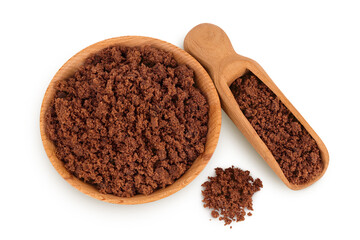 Dark muscovado sugar or Barbados sugar in wooden bowl isolated on white background. Top view. Flat lay