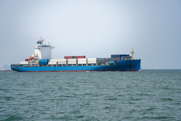 Side view of Cargo ship carrying container from custom container depot go to ocean concept freight shipping by ship service on blue sky .Freight Forwarding Service