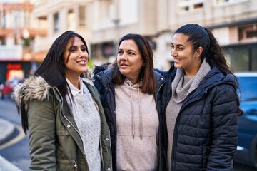 Three woman mother and daughters standing together at street