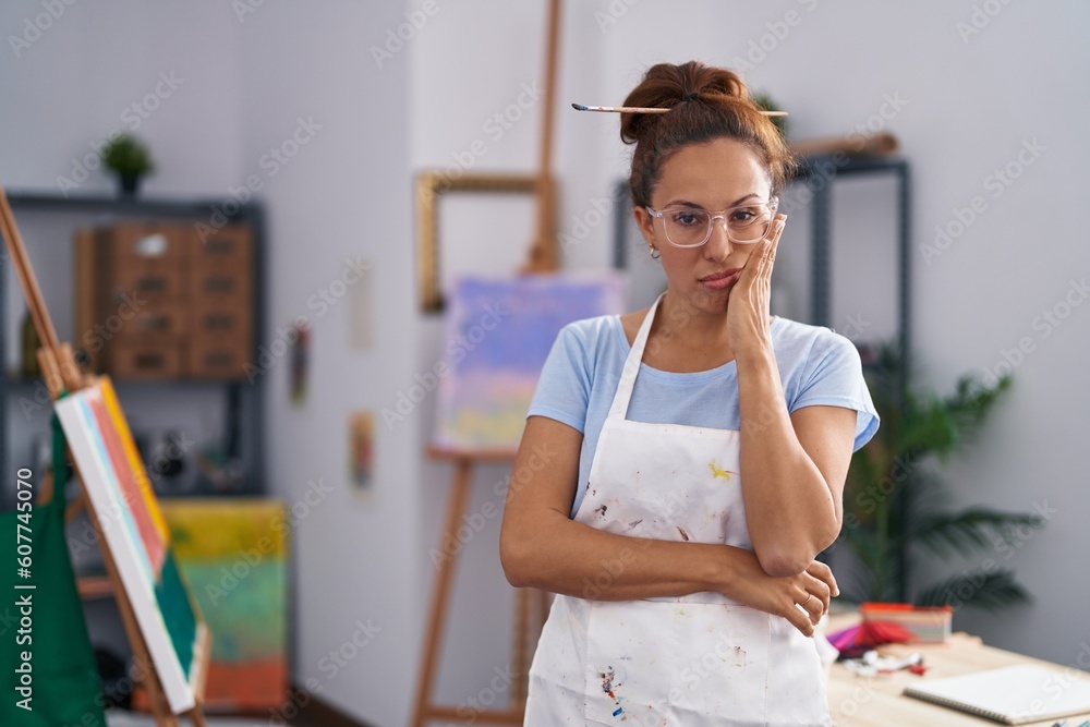 Sticker Brunette woman painting at art studio thinking looking tired and bored with depression problems with crossed arms.