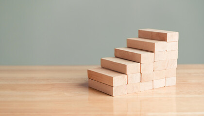 Wooden blocks stacking for arrangement and development as stair steps construction shape. Business growth success and Education development practice plan project. Progress and management