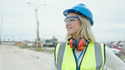 Young blonde woman architect smiling confident looking to the side at street