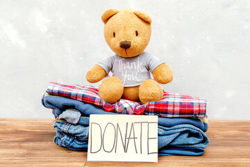 Old baby children clothes,teddy bear toy.Donation, volunteering help,humanitarian aid,charity Stack...