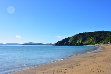 Fototapeta na wymiar Calm sea with practically no surf wave at Long Beach in Russell. Location: Russell New Zealand