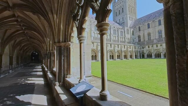 The cloisters and internal grass courtyard at the majestic cathedral in the city of Norwich. Captured on a bright and sunny morning