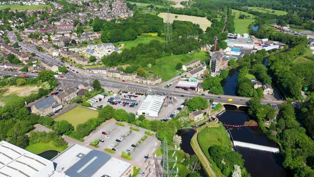 Aerial footage of the village of Kirkheaton, Huddersfield in the Kirklees district in the county of West Yorkshire England showing the village and River Calder from above in the summer time.