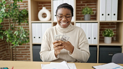 African american woman business worker counting dollars at office