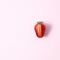 Strawberry fruit on pastel pink background. Minimal flat lay concept