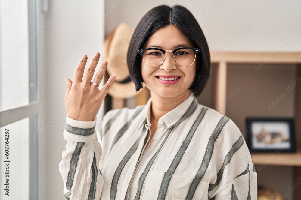 Sticker Young chinese woman smiling confident wearing engagement ring at home