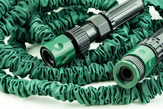 1 Green flexible garden hose close up