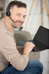 smiling young man using technology to work