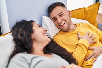 Man and woman couple smiling confident lying on bed at bedroom