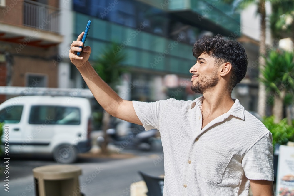 Canvas Prints Young arab man smiling confident making selfie by the smartphone at street