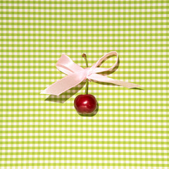Cherry fruit, creative aesthetic food layout, retro romantic style, green checkered pattern background.