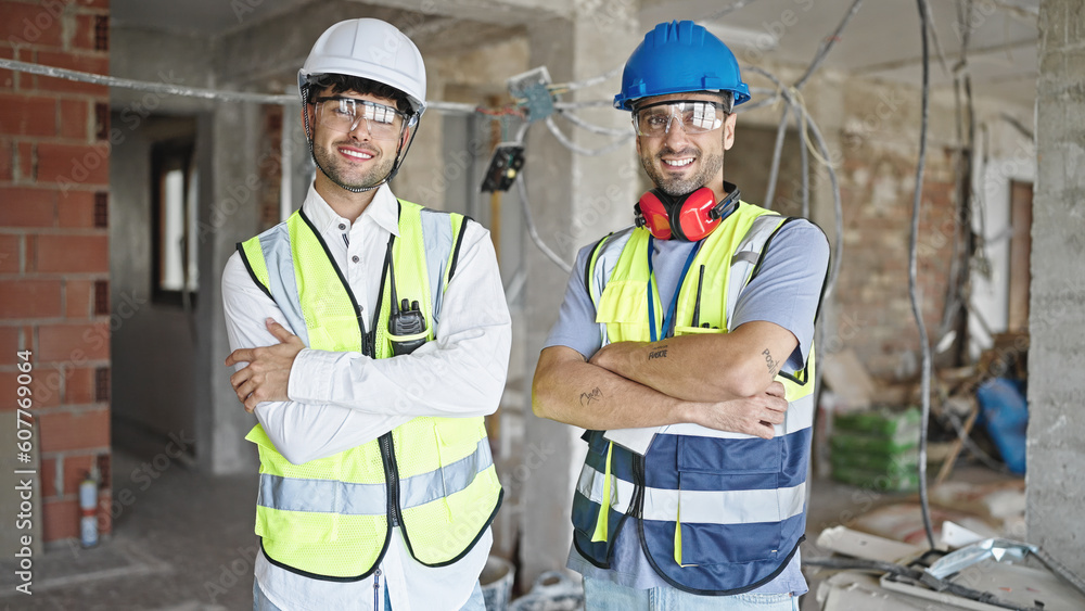 Canvas Prints Two men builders smiling confident standing with arms crossed gesture at construction site