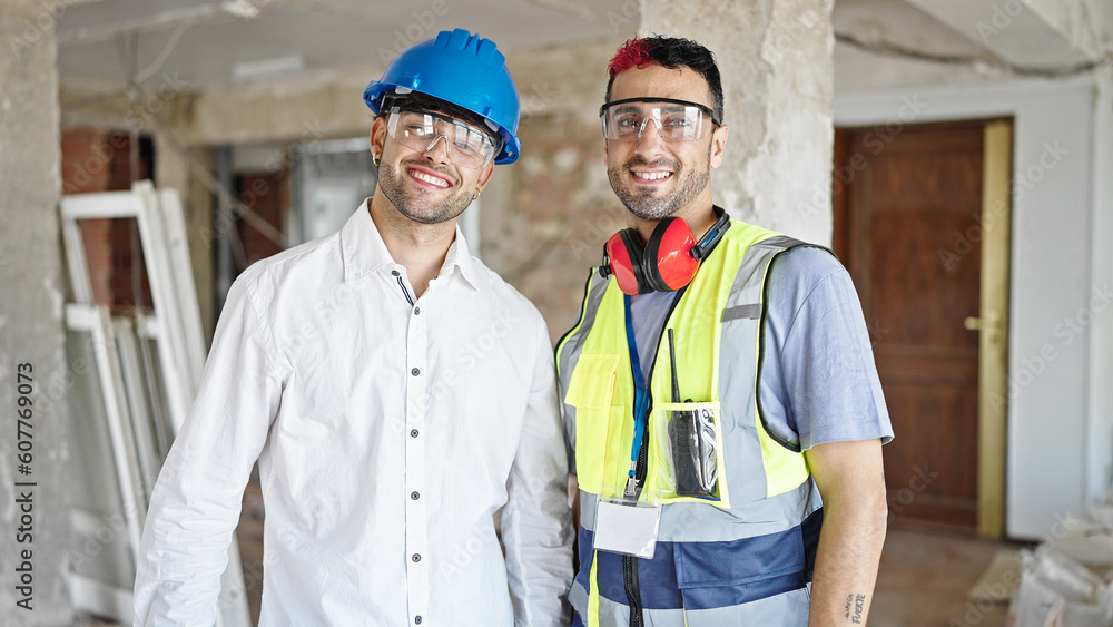 Canvas Prints Two men builder and architect smiling confident standing together at construction site