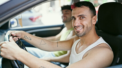 Two men couple smiling confident driving car at street