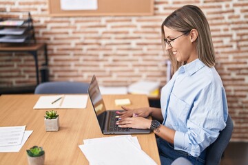 Young beautiful hispanic woman business worker smiling confident using laptop at office