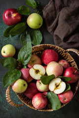 Fruit background, organic fruits. Still life food. Basket of ripe apples on a stone table. View from above. Copy space.