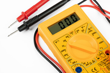 Digital multimeter with probes on a white background. 