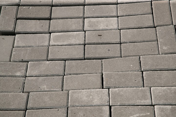 Old square paving slabs laid out in vertical rows. Processing of materials, recycling and storage of bricks.