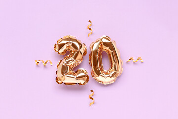 Number 20 gold inflatable balloons with ribbon confetti on a purple pastel background.