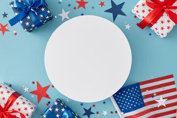Obraz premium Fourth of July concept. Top view flat lay of gift boxes in patriotic colors, national flag, star-shaped confetti on light blue background with empty circle for text or ads