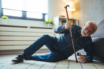 A Disabled Retiree with Walking Cane Fell on the Floor of the Living Room. Disabled Senior Man...