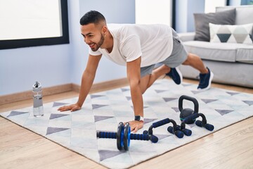 African american man smiling confident training abs exercise at home