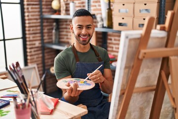 African american man artist smiling confident drawing at art studio
